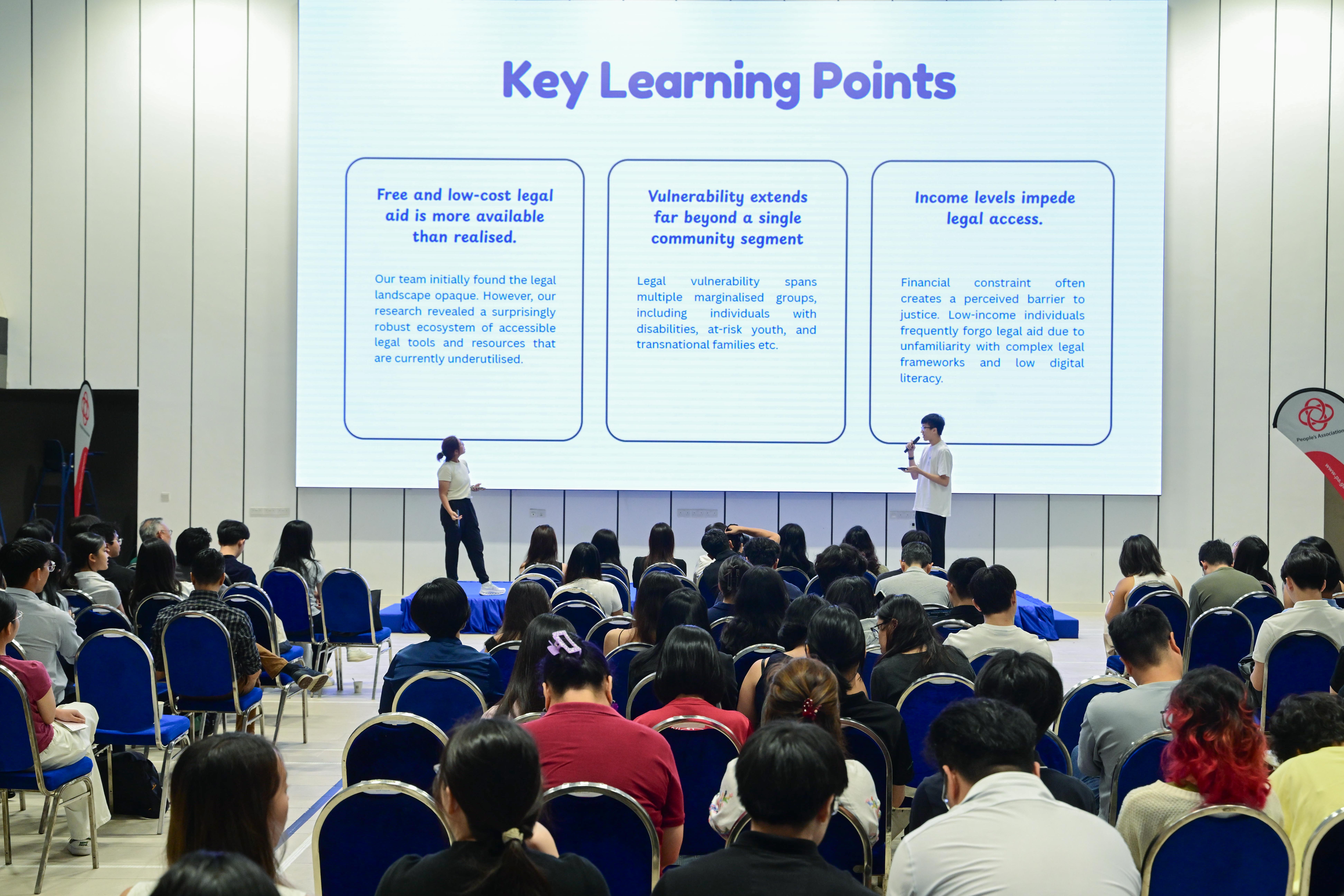 Two students explaining their group's key learning points